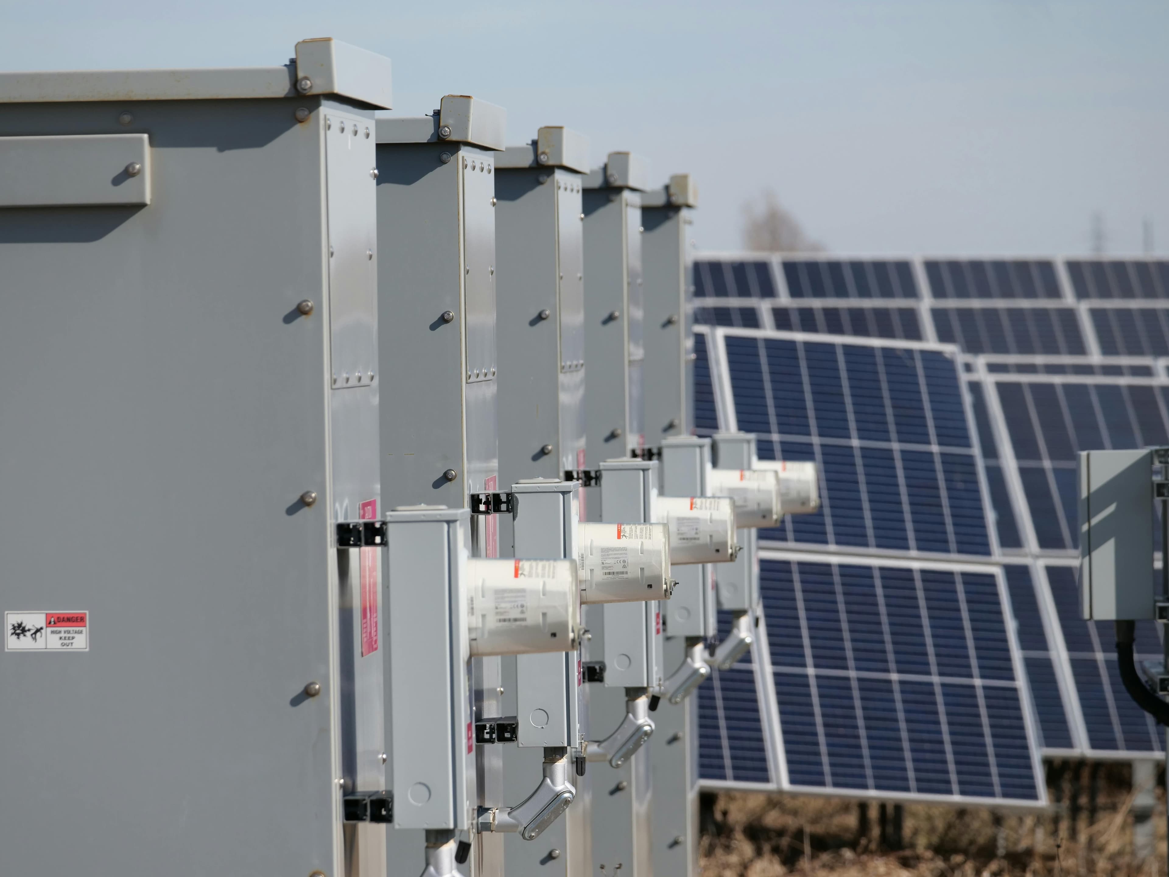 Large-scale solar array with inverter equipment in the foreground